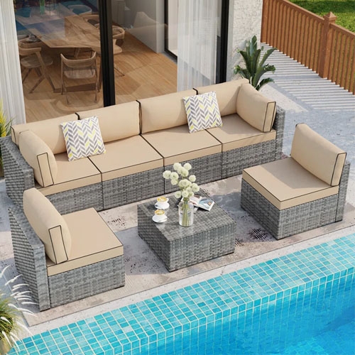 Outdoor wicker sectional sofa set with beige cushions and a matching coffee table.