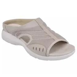A beige slip-on sandal with mesh and suede detailing, featuring a peep-toe design and white cushioned sole for comfort.