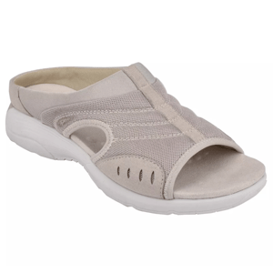 A beige slip-on sandal with mesh and suede detailing, featuring a peep-toe design and white cushioned sole for comfort.