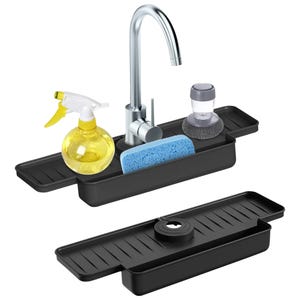Black sink caddy with a faucet hole, two adjustable side trays, and items like a sponge, scrubber, and spray bottle on top for organizing cleaning supplies.
