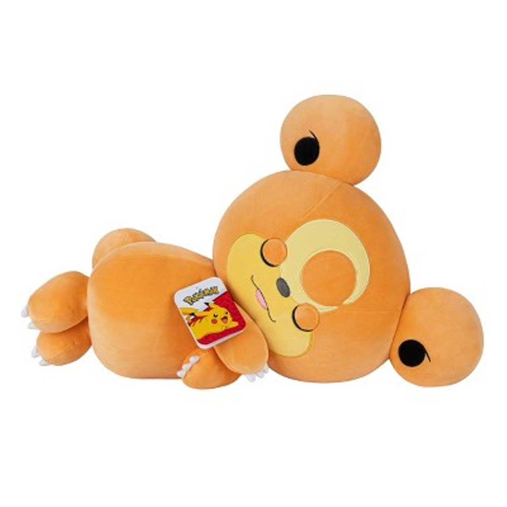 A plush toy of the Pokémon Teddiursa, featuring a round orange body with closed eyes, lying on its side. A tag with the Pokémon logo and Pikachu is attached.