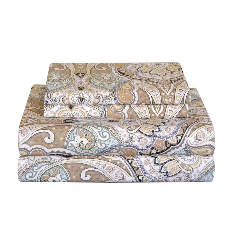 A stack of 100% cotton percale sheet sets featuring a paisley pattern in beige, white, and light blue tones. The pattern is intricate, with swirling designs and floral elements.