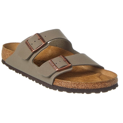 A slide sandal with two adjustable leather straps, a cork-latex footbed, and metal buckles. The sole is black with a slightly raised heel.