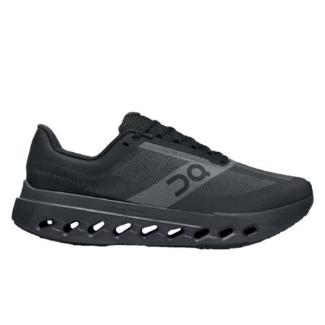The On Cloudsurfer Next are black running shoes featuring a sleek design with a mesh upper for breathability and distinctive cut-out details in the sole for cushioning and flexibility.