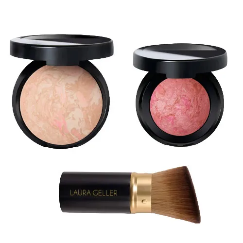Two compacts with marbled powder makeup, one in a beige tone and the other in pink, alongside a makeup brush labeled \“Laura Geller\“.