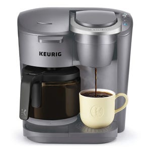 The Keurig K-Duo Coffee Maker features a dual function with a drip coffee carafe and a single-serve K-Cup option. It's a versatile silver machine, allowing for both a full pot and individual coffee servings.