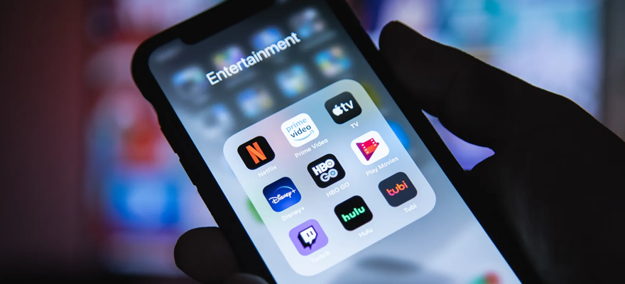 A cell phone screen shows icons for discounted streaming services.