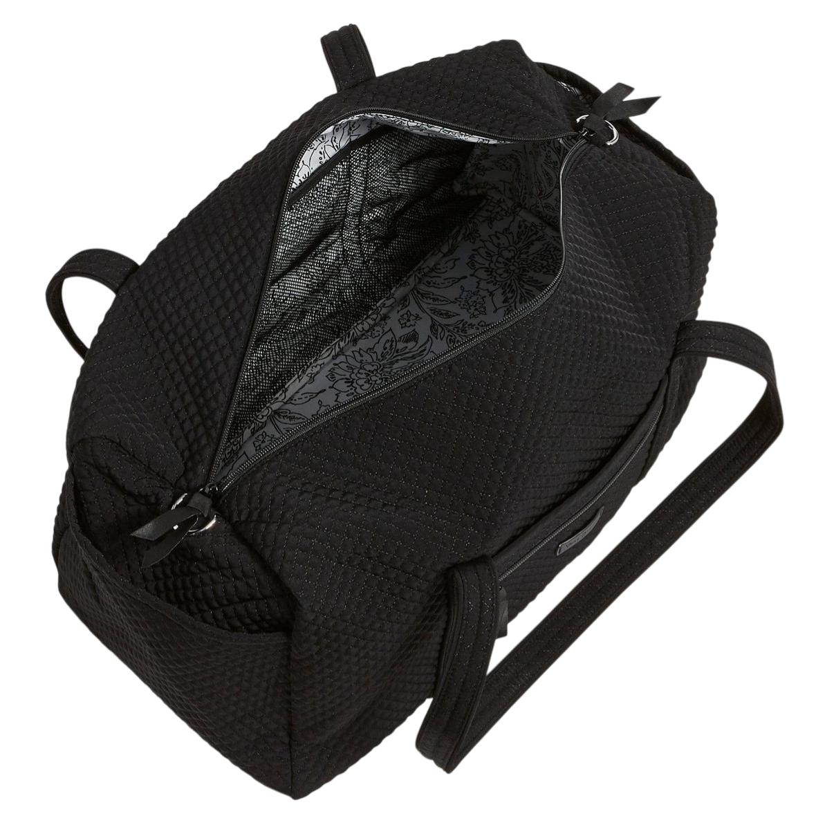 A black quilted bag with a spacious interior featuring a floral patterned lining, two handles, and a zippered opening.