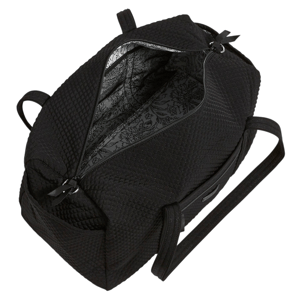 A black quilted bag with a spacious interior featuring a floral patterned lining, two handles, and a zippered opening.