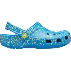 Blue clog with a speckled design of yellow, white, and green. Features a strap with a green circular logo.