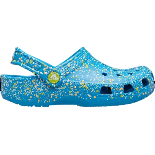 Blue clog with a speckled design of yellow, white, and green. Features a strap with a green circular logo.