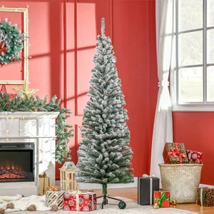 A decorated Christmas tree with presents beneath it stands beside a fireplace adorned with festive decor.