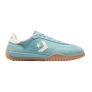 A light blue low-top sneaker with a white star and chevron logo, featuring a textured gum sole and suede material.