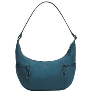 A teal, crescent-shaped sling bag with a shoulder strap, featuring two front zippered pockets and a small logo at the center.