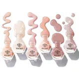 Modelones nail polish bottles are arranged in a row, featuring a variety of nude and glittery shades with decorative spills around them.