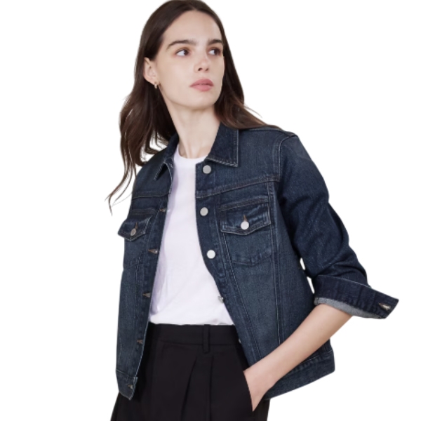 A dark blue cropped denim jacket with front button closure, chest flap pockets, long sleeves with rolled cuffs, and a classic collar worn over a white shirt and black pants.