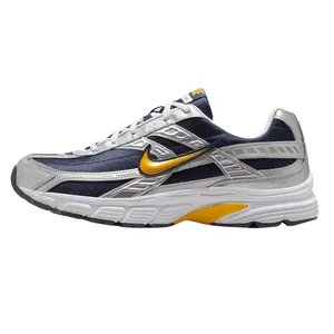 Athletic shoe with a blue and silver mesh design, featuring a yellow swoosh logo and a white, textured sole.