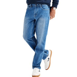 A person is wearing blue jeans paired with white sneakers featuring a blue logo and gum soles, along with part of a dark long-sleeve shirt.