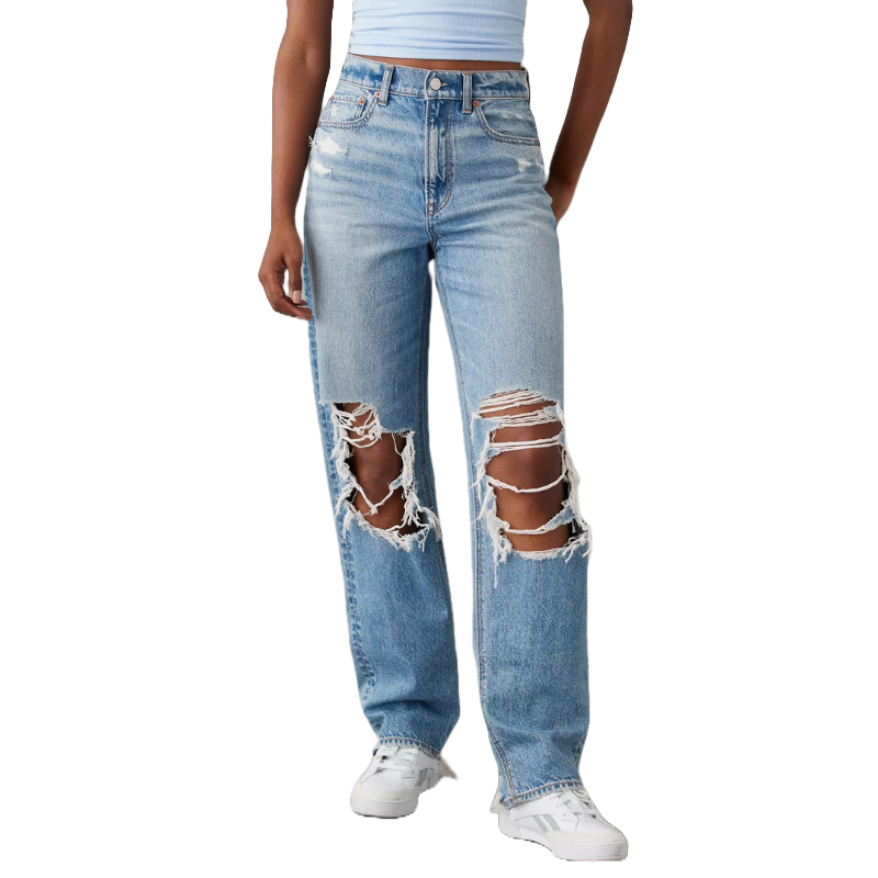 Light blue ripped baggy straight jeans with large distressed holes on both legs, high-waisted with a button and zip closure, paired with a light blue top and white sneakers.