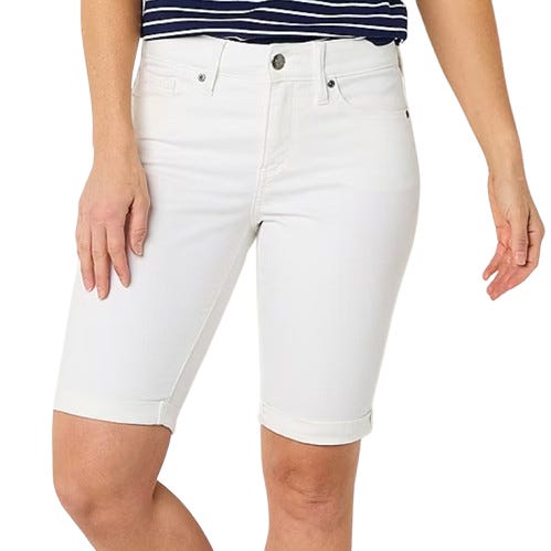 White knee-length denim shorts with a cuffed hem, front button, and zip closure, paired with a navy and white striped top.