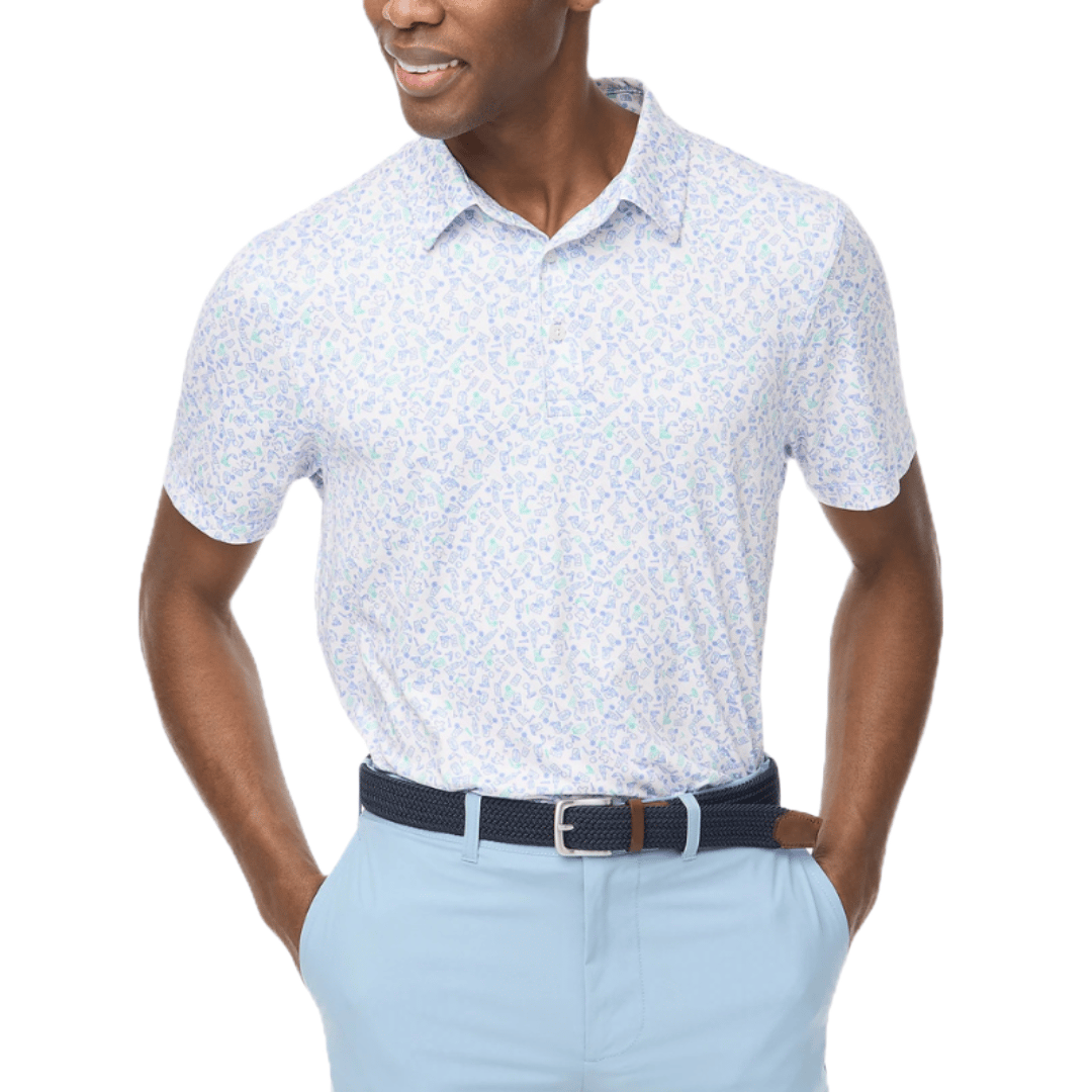 A man is wearing a short-sleeve, light-colored polo shirt with a subtle colorful print, paired with light blue pants and a dark belt.