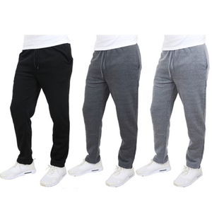 Three pairs of jogger pants in black, dark gray, and light gray, worn with white sneakers.