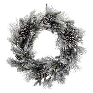 A snow-flocked wreath adorned with frosted pine needles and several pinecones, creating a wintry, festive look.