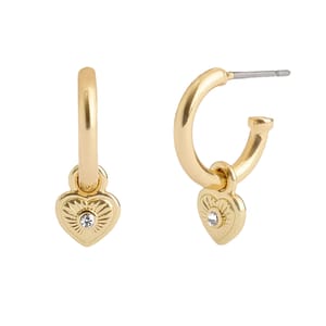 Gold-toned huggie hoop earrings featuring a heart-shaped charm with a central sparkling stone on each.