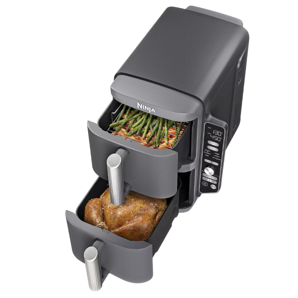 Dual-drawer air fryer with digital controls, cooking roasted chicken in one drawer and vegetables like green beans in the other.
