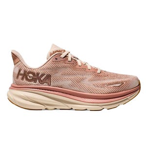 The Hoka Clifton 9 Running Shoes feature a pink and beige color scheme with a thick, cushioned sole for comfort. The design includes a breathable mesh upper and large Hoka branding on the side.