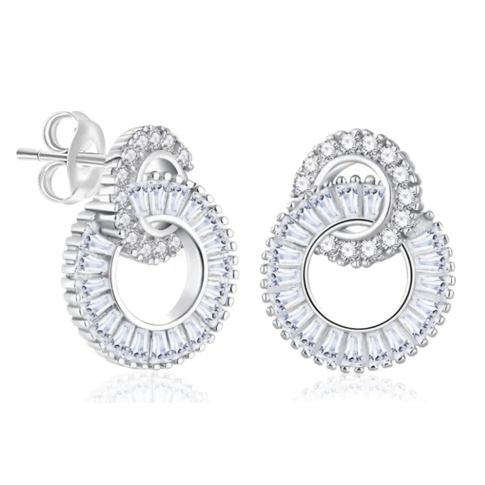 Silver stud earrings with two interlocking circles; one large with baguette-cut stones and one smaller adorned with round stones, creating an elegant, intertwined design.