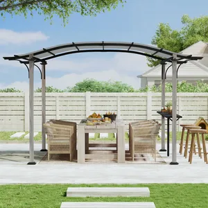 A patio setup with a wooden dining table, chairs, and bar stools is underneath a gray metal pergola. There's also an outdoor grill and a doghouse in the background, all set in a backyard with a white fence.