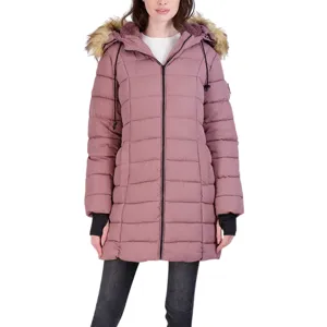 A woman wearing a long, dusty pink puffer coat with a fur-trimmed hood, black jeans, and black slip-on shoes.