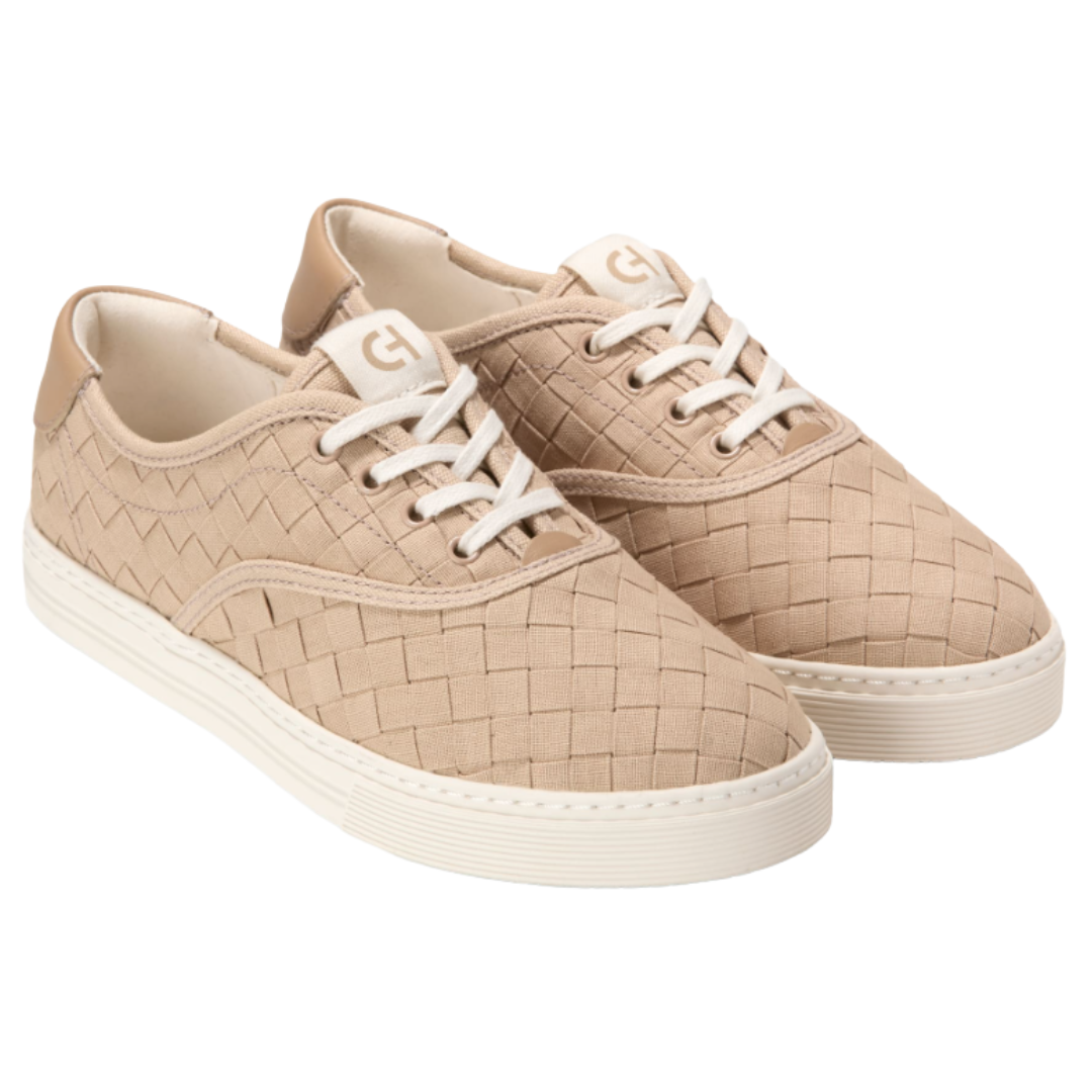Beige woven sneakers with white laces and a flat sole, featuring a subtle geometric pattern.