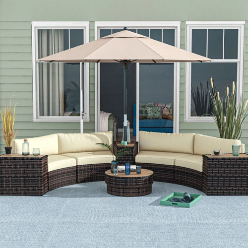 Outdoor rattan furniture set with cushions, a round table, and an umbrella.