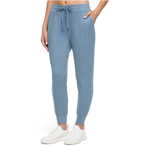 Light blue jogger pants with an elastic waistband, drawstring, and ankle cuffs, worn with white sneakers.