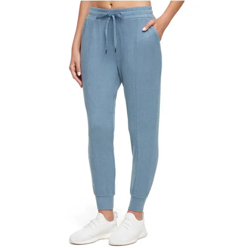 Light blue jogger pants with an elastic waistband, drawstring, and ankle cuffs, worn with white sneakers.