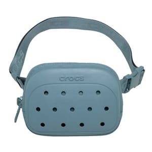 A light blue crossbody bag with a design resembling Crocs shoes, featuring ventilation holes and an adjustable strap with the brand name \“Crocs\“ embossed on it.