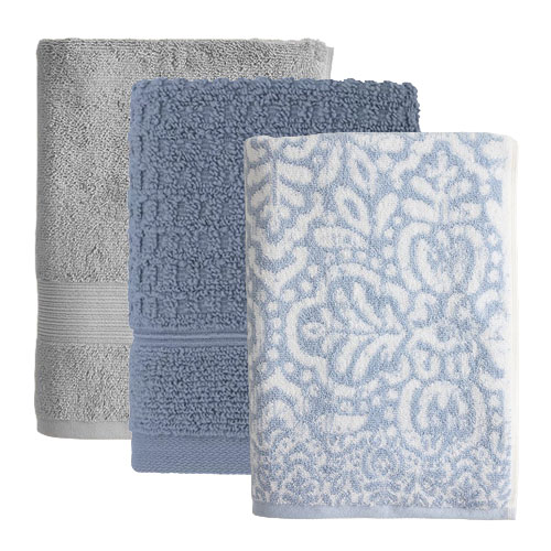 Three folded towels in different patterns and textures: one solid gray, one textured blue, and one white with blue floral patterns.