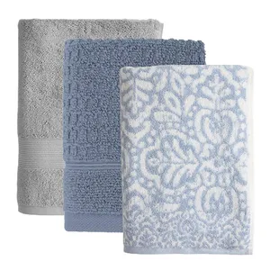 Three folded towels in different patterns and textures: one solid gray, one textured blue, and one white with blue floral patterns.