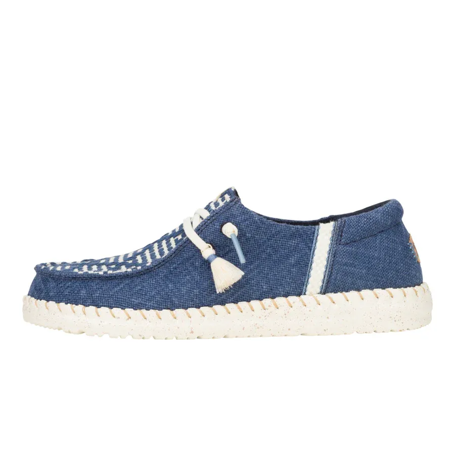 Casual blue slip-on shoe with white accents and a textured sole. Features a white cord with a tassel on the side and a stitched design on the upper.