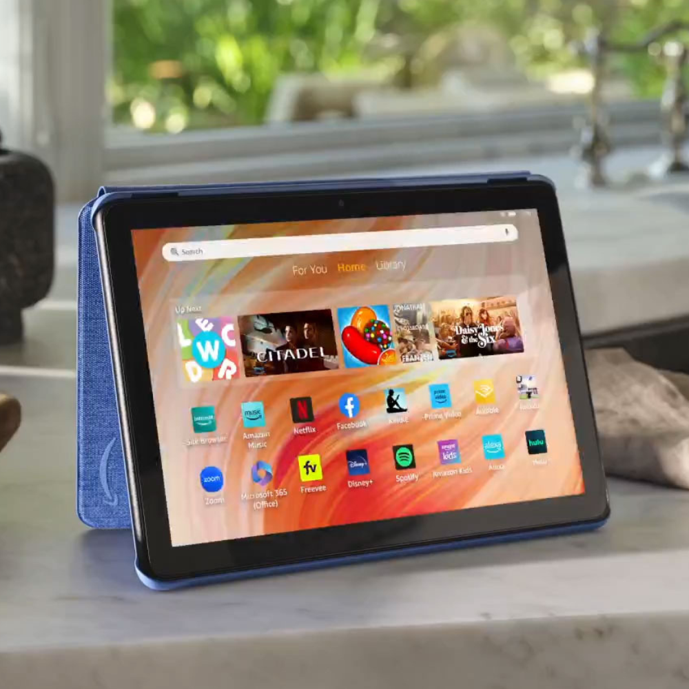 A tablet with a blue case is displayed on a stand, showing a home screen with app icons like Netflix, Facebook, and Spotify, along with featured content suggestions.