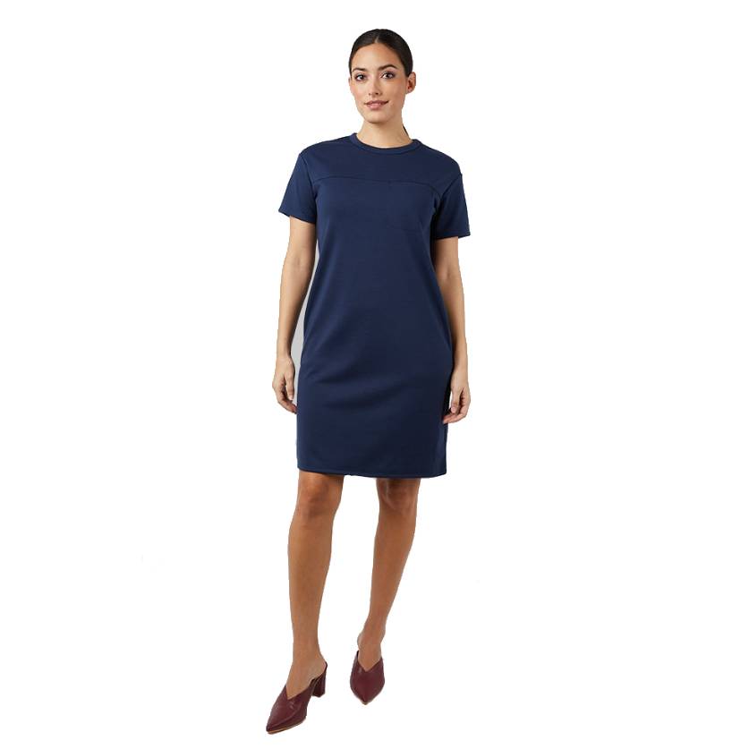 A woman is wearing a short-sleeved, knee-length navy blue dress paired with maroon shoes.