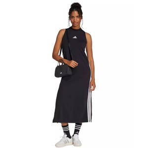 Black Adidas maxi dress featuring a sleeveless design with a high neckline, side stripes, and a small Adidas logo on the front. Paired with matching accessories: a small black bag, socks, and white sneakers.