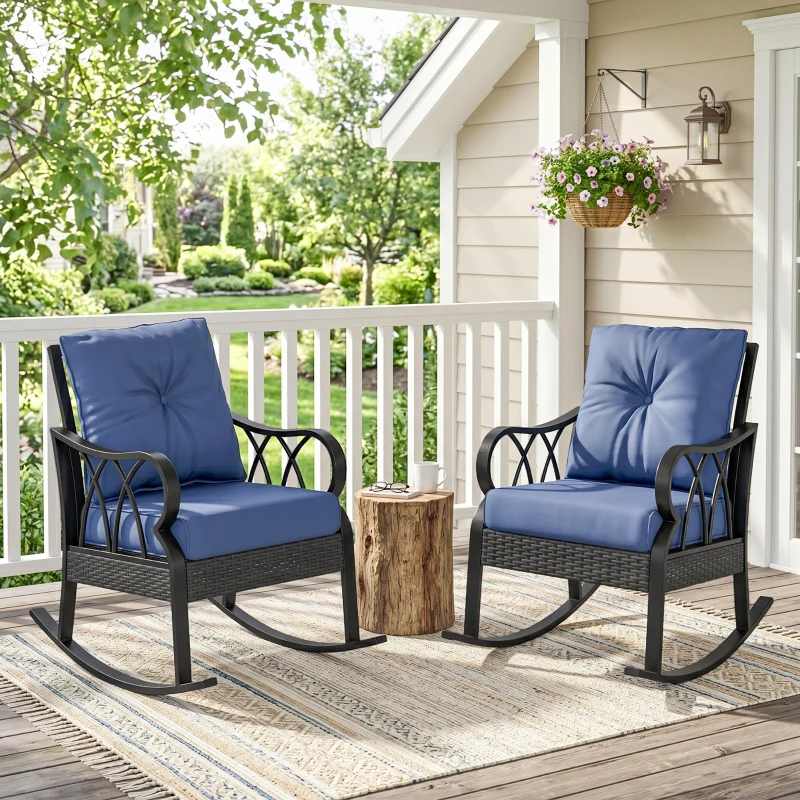 Two blue cushioned rocking chairs with black frames on a porch, accompanied by a small wooden stump table, a hanging flower basket, and a patterned rug.