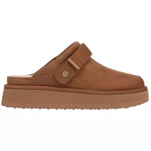 A tan slip-on mule with a thick sole and adjustable strap, featuring a subtle stitched design and a small metal accent.