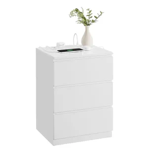 White three-drawer chest with a vase of greenery on top, alongside a smartphone, wireless mouse, and charging accessories.