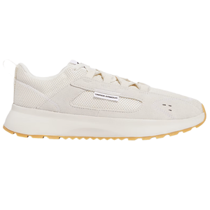 Under Armour sneaker in off-white with a mesh and suede design, featuring a gum rubber sole and a visible logo tag on the side.