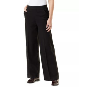 A pair of black wide-leg trousers with side pockets, worn with a white top and brown shoes.