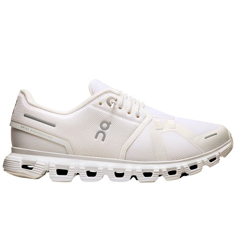 White athletic shoe with a mesh upper, distinctive cushioning, and a unique sole design featuring cut-out sections.